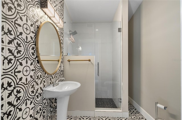 bathroom with tile patterned flooring and a shower with shower door