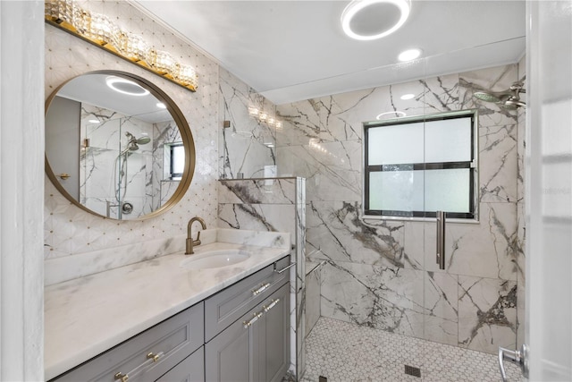 bathroom featuring a tile shower and vanity