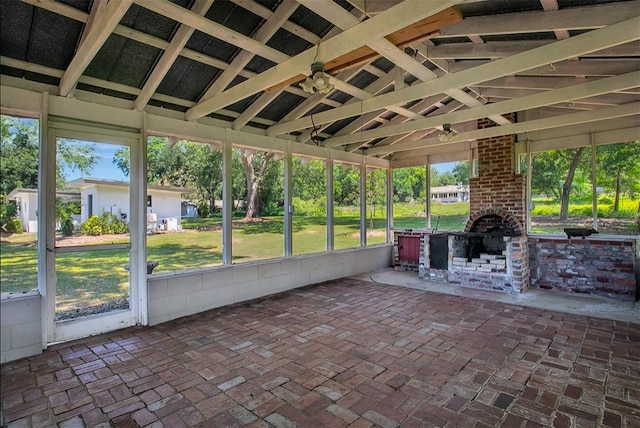 unfurnished sunroom featuring vaulted ceiling