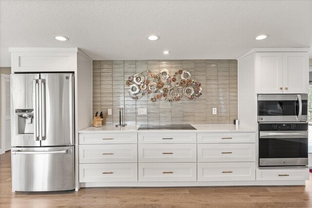 12550 Lakeshore Dr, Clermont, FL 34711 - kitchen with stainless steel appliances, recessed lighting, white cabinets, backsplash, and light countertops