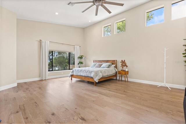 12550 Lakeshore Dr, Clermont, FL 34711 - bedroom with a towering ceiling, light wood-style floors, recessed lighting, and a ceiling fan