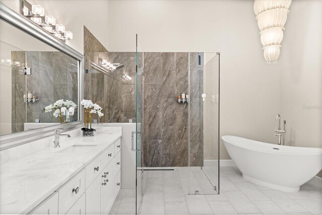 12550 Lakeshore Dr, Clermont, FL 34711 - bathroom with marble look tiles, vanity, a freestanding tub, and a marble finish shower