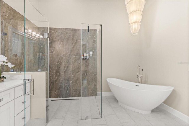12550 Lakeshore Dr, Clermont, FL 34711 - bathroom with marble look tile flooring, a freestanding bath, a marble finish shower, and vanity