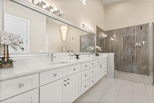 12550 Lakeshore Dr, Clermont, FL 34711 - full bathroom featuring double vanity, a marble finish shower, and marble finish floors