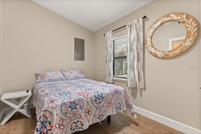 12550 Lakeshore Dr, Clermont, FL 34711 - bedroom featuring wood finished floors, lofted ceiling, and electric panel