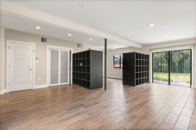 12550 Lakeshore Dr, Clermont, FL 34711 - unfurnished living room featuring recessed lighting, wood finished floors, a ceiling fan, and beamed ceiling