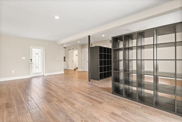 12550 Lakeshore Dr, Clermont, FL 34711 - empty room with light wood-type flooring, a barn door, and recessed lighting