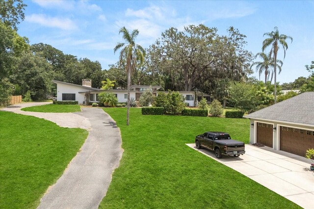12550 Lakeshore Dr, Clermont, FL 34711 - view of grassy yard featuring driveway and view of scattered trees