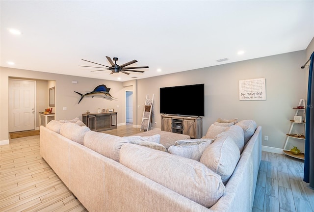 living room with ceiling fan and light hardwood / wood-style flooring