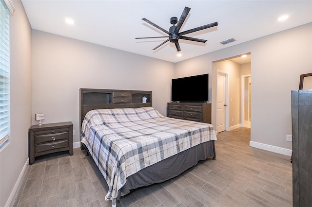 bedroom featuring multiple windows, ceiling fan, and light hardwood / wood-style flooring