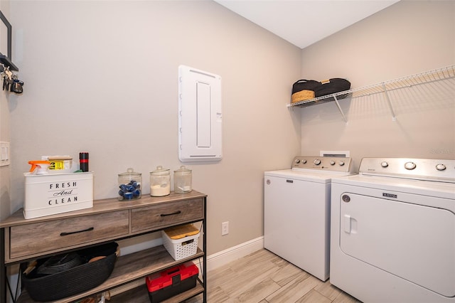 clothes washing area featuring light hardwood / wood-style floors and washing machine and clothes dryer