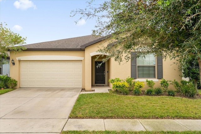 view of front of home with a front lawn and a garage