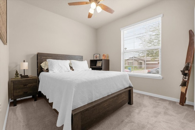 bedroom with light colored carpet, multiple windows, and ceiling fan