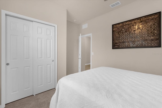 bedroom with a closet and light colored carpet