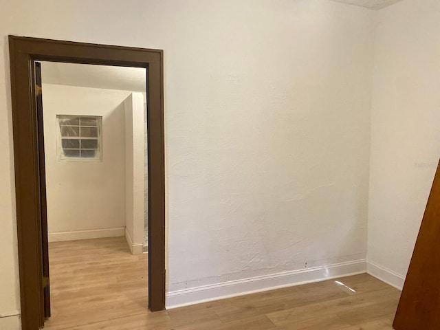 corridor with light wood-type flooring