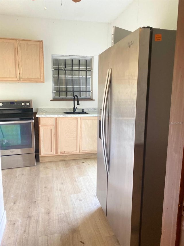 kitchen featuring light hardwood / wood-style floors, sink, stainless steel appliances, and light brown cabinets