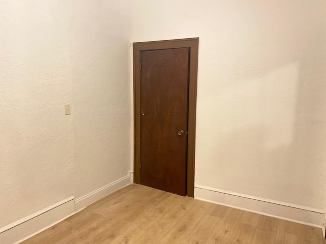 unfurnished room with hardwood / wood-style floors