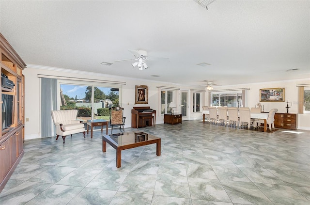 living room with ceiling fan and ornamental molding