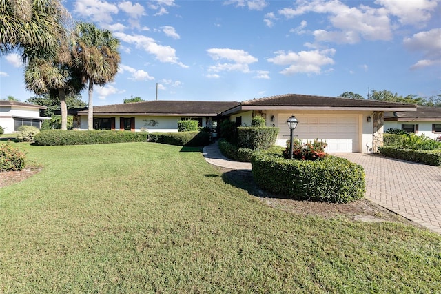 single story home featuring a front yard and a garage