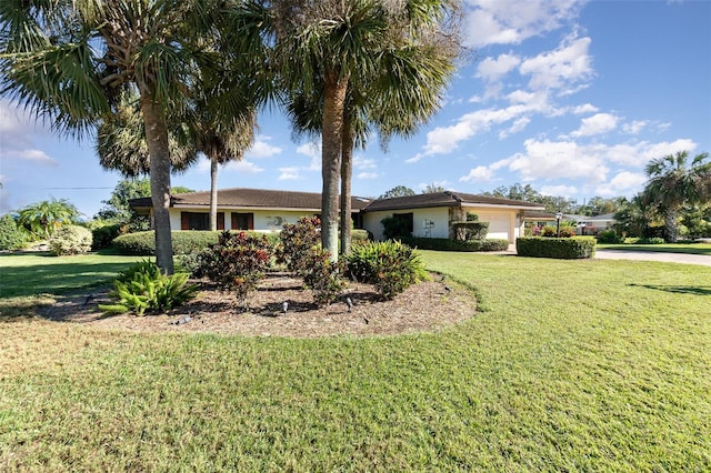 view of front of home featuring a garage and a front lawn