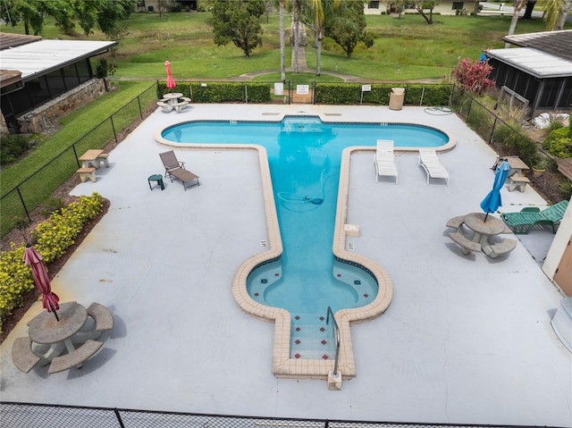 pool featuring a yard, fence, and a patio