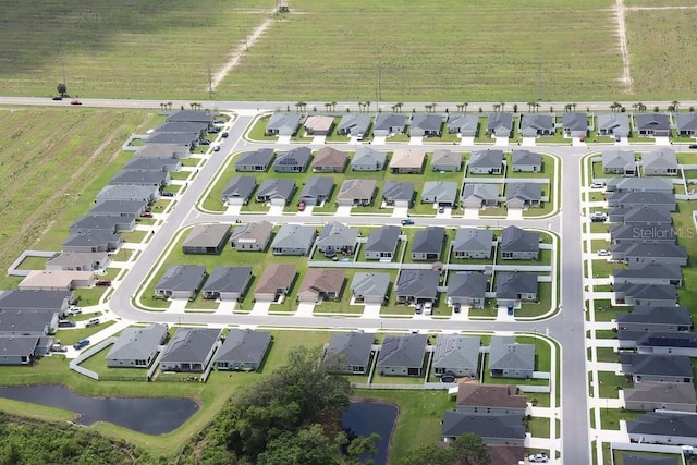 birds eye view of property with a residential view and a water view