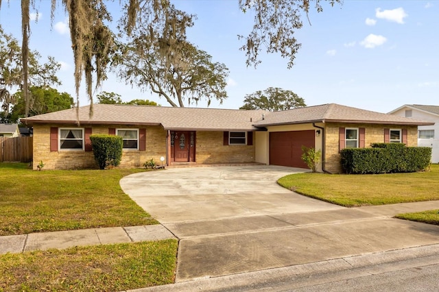 ranch-style house featuring a garage and a front lawn