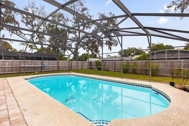 view of swimming pool with a patio and glass enclosure