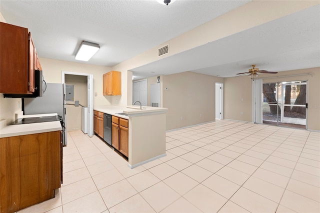 kitchen with dishwasher, sink, ceiling fan, a textured ceiling, and light tile patterned flooring