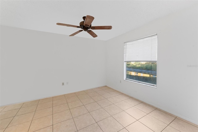 unfurnished room featuring ceiling fan and light tile patterned floors