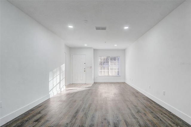 unfurnished room with dark hardwood / wood-style flooring