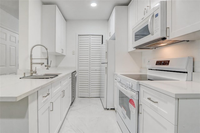 kitchen featuring white cabinetry, white appliances, and sink