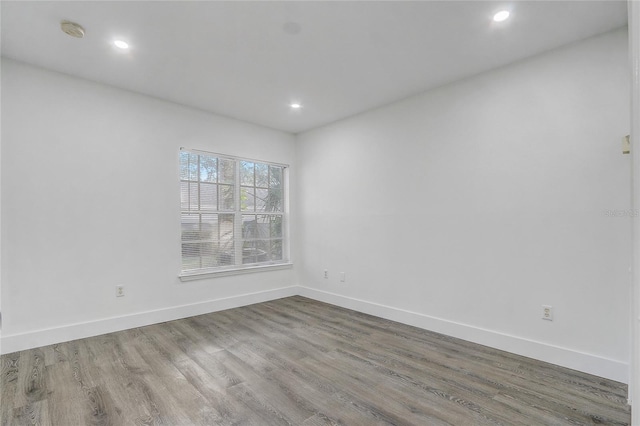 unfurnished room with hardwood / wood-style floors