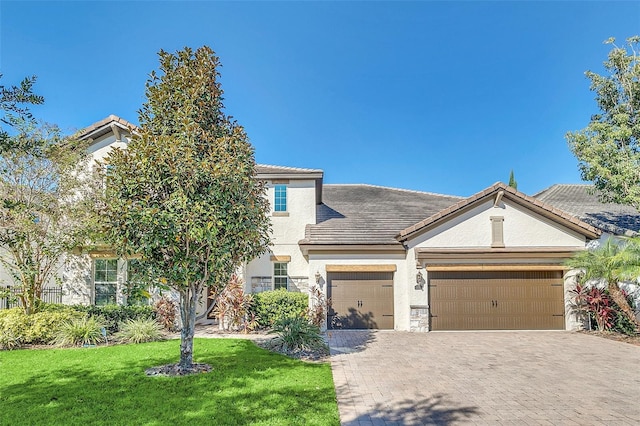 view of front of property with a front yard and a garage