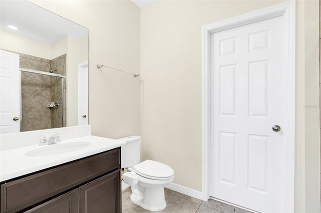 bathroom with toilet, vanity, tile patterned floors, and an enclosed shower