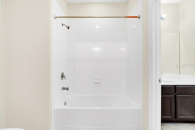 bathroom with vanity and tiled shower / bath