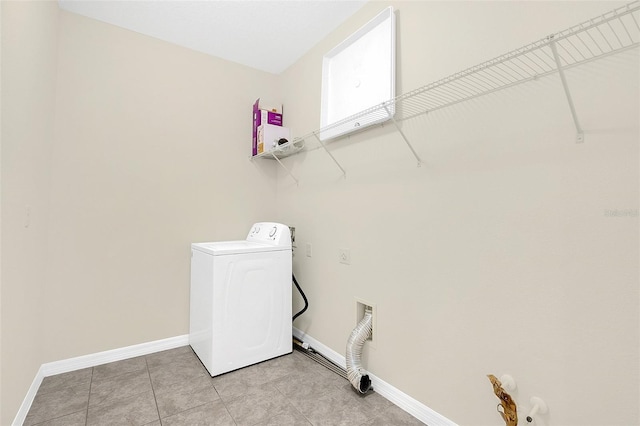 laundry room featuring washer / clothes dryer and light tile patterned floors