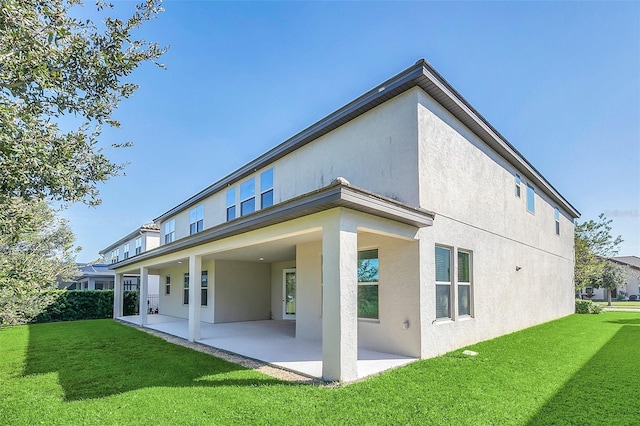 back of house featuring a patio area and a yard