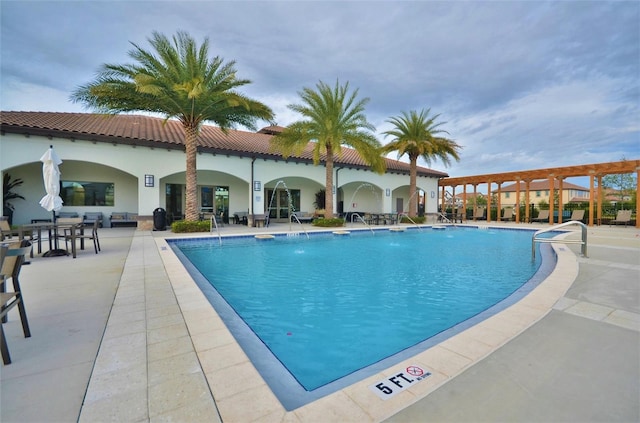 view of pool featuring pool water feature and a patio area