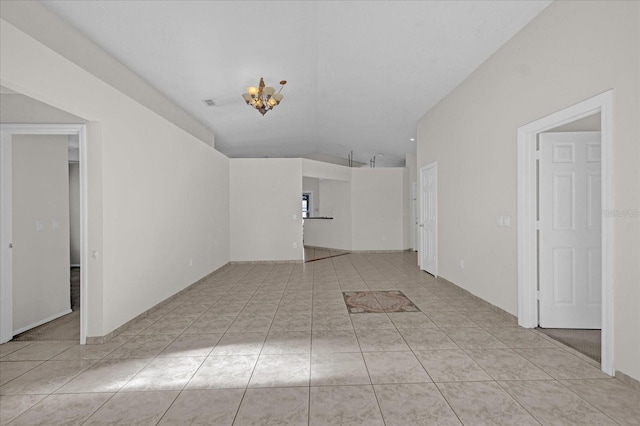 interior space with light tile patterned flooring and vaulted ceiling