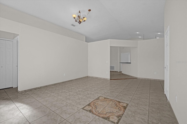 interior space with light tile patterned flooring and a chandelier