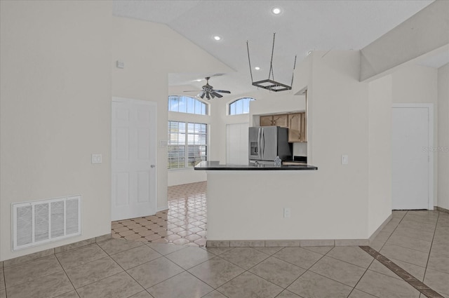 kitchen with stainless steel fridge with ice dispenser, light brown cabinetry, light tile patterned floors, and ceiling fan