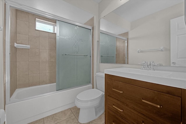 full bathroom featuring tile patterned flooring, combined bath / shower with glass door, toilet, and vanity