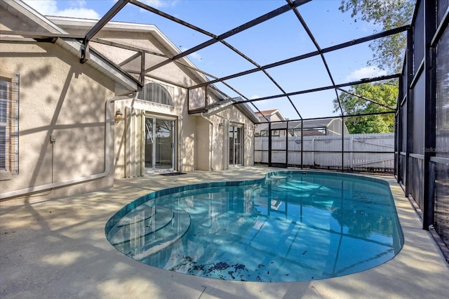 view of swimming pool with a patio and a lanai