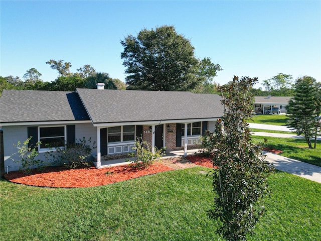 ranch-style home with a porch and a front lawn