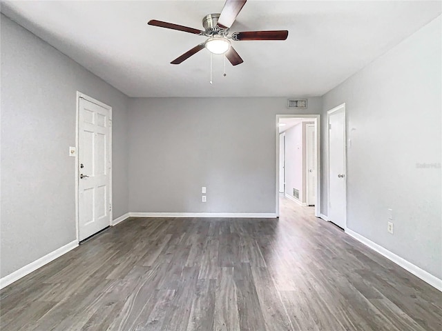 spare room featuring ceiling fan and dark hardwood / wood-style flooring