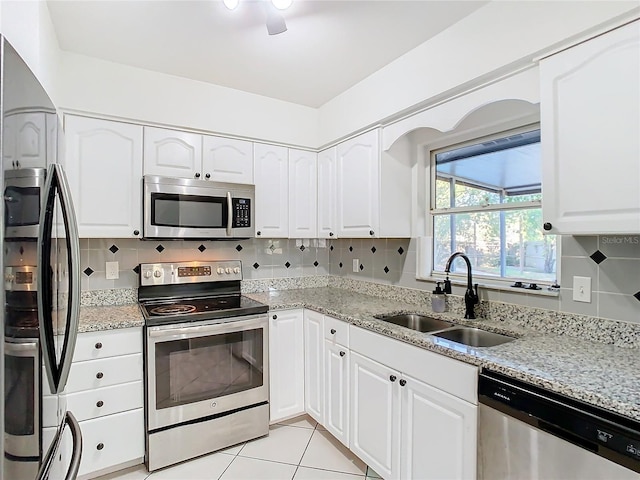 kitchen featuring stainless steel appliances, white cabinetry, and sink