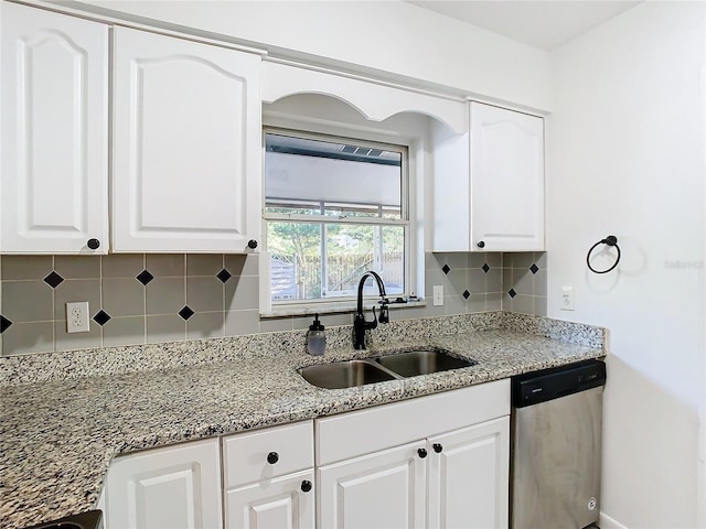 kitchen with white cabinetry, dishwasher, light stone countertops, sink, and decorative backsplash