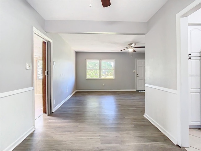 spare room with dark hardwood / wood-style flooring and ceiling fan