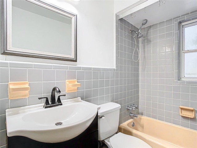 full bathroom featuring vanity, toilet, and tiled shower / bath